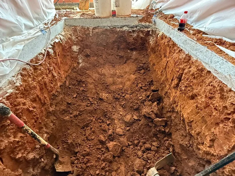 Excavation through a saw-cut concrete restaurant floor for a grease interceptor