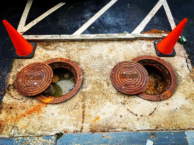 Two concrete septic tank lids uncovered and ready for service