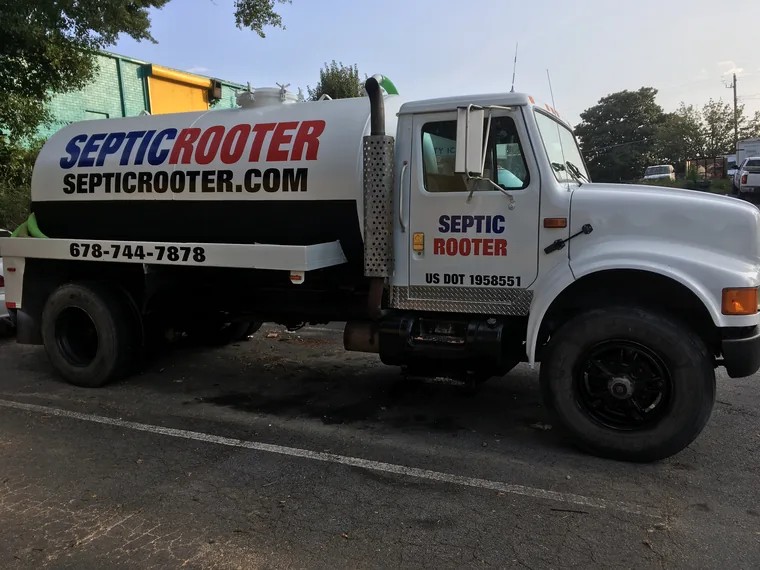 SepticRooter pump truck parked at a residential septic job