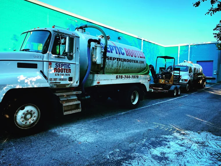 SepticRooter team members in front of a branded truck