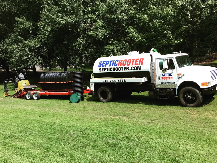 SepticRooter pump truck on a residential yard septic service call